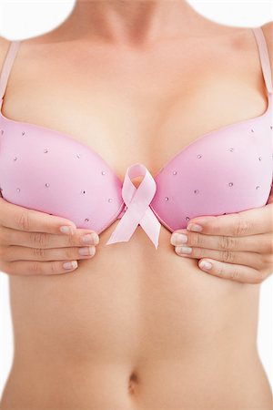 simsearch:400-06870717,k - Closeup of woman with breast cancer awareness ribbon attached to bra over white background Stock Photo - Budget Royalty-Free & Subscription, Code: 400-06870717