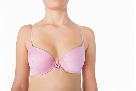 Midsection of woman in pink bra standing over white background Stock Photo - Budget Royalty-Free & Subscription, Code: 400-06870711