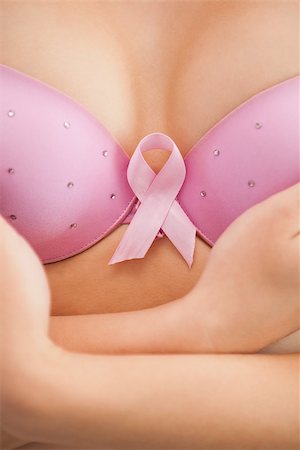 simsearch:400-06870717,k - Closeup of woman in bra with breast cancer awareness ribbon Stock Photo - Budget Royalty-Free & Subscription, Code: 400-06870720