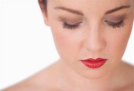 simsearch:614-06897685,k - Closeup of young woman with red lips over white background Photographie de stock - Aubaine LD & Abonnement, Code: 400-06870892