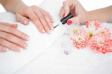 Closeup of woman applying nail varnish to finger nails at nail salon Stock Photo - Budget Royalty-Free & Subscription, Code: 400-06871090