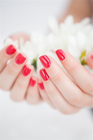 Closeup of manicured hands holding flowers at spa center Stock Photo - Budget Royalty-Free & Subscription, Code: 400-06871091