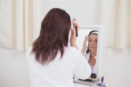 photography of someone putting on makeup in mirror - Young woman looking at mirror and putting on makeup Stock Photo - Budget Royalty-Free & Subscription, Code: 400-06871168