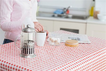 simsearch:400-06871178,k - Midsection of woman with kettle and coffee cup in the kitchen Stock Photo - Budget Royalty-Free & Subscription, Code: 400-06871176