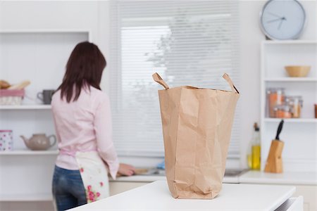 rear of house - Rear view of young woman working in the kitchen Foto de stock - Super Valor sin royalties y Suscripción, Código: 400-06871181