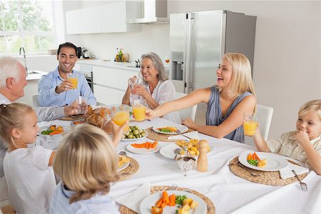 simsearch:400-06871551,k - Family raising their glasses together before eating Stock Photo - Budget Royalty-Free & Subscription, Code: 400-06871586
