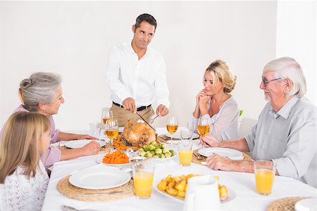 simsearch:400-06871551,k - Man cutting slices of turkey for family dinner Stock Photo - Budget Royalty-Free & Subscription, Code: 400-06871580