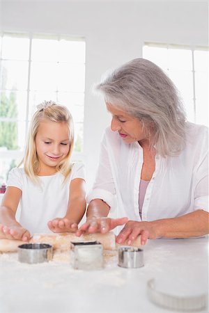 Granddaughter making biscuits with her grandmother in the kitchen Stock Photo - Budget Royalty-Free & Subscription, Code: 400-06871595