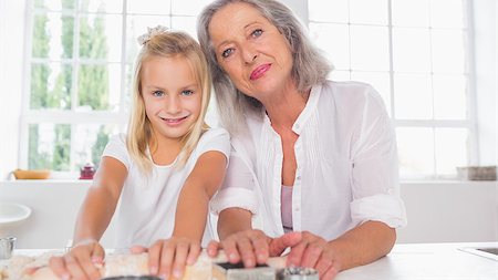 Granddaughter making biscuits with her grandmother in the kitchen Stock Photo - Budget Royalty-Free & Subscription, Code: 400-06871596