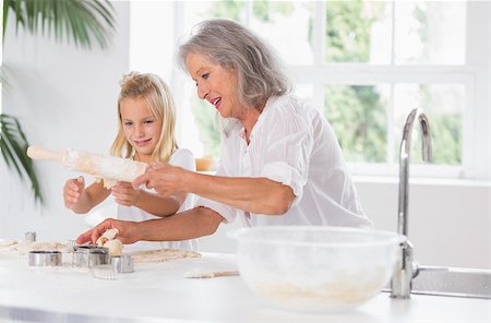 Grandmother and granddaughter using a rolling pin in the kitchen Stock Photo - Budget Royalty-Free & Subscription, Code: 400-06871600