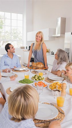 simsearch:400-06871551,k - Mother serving a roast turkey for thanksgiving Stock Photo - Budget Royalty-Free & Subscription, Code: 400-06871614