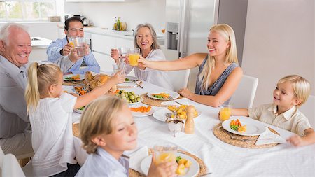 simsearch:400-06871557,k - Happy family raising their glasses together for thanksgiving Photographie de stock - Aubaine LD & Abonnement, Code: 400-06871623