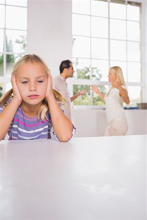 divorced family - Girl looking despressed in front of fighting parents in the kitchen Stock Photo - Budget Royalty-Free & Subscription, Code: 400-06871661