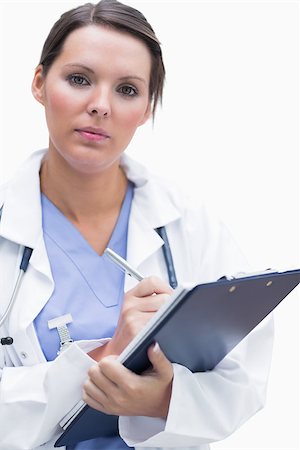 reports white background - Portrait of female doctor with clipboard over white background Stock Photo - Budget Royalty-Free & Subscription, Code: 400-06871888