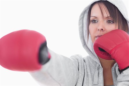 simsearch:400-06876600,k - Serious young woman in boxing stance over white background Stock Photo - Budget Royalty-Free & Subscription, Code: 400-06871955