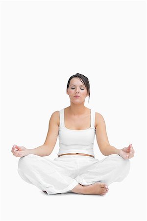 simsearch:400-06872329,k - Young woman sitting in lotus position over white background Foto de stock - Super Valor sin royalties y Suscripción, Código: 400-06871998