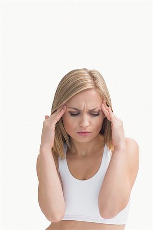 Young woman rubbing her temples over white background Stock Photo - Budget Royalty-Free & Subscription, Code: 400-06872060