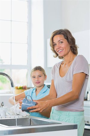 simsearch:6109-08488688,k - Mother washing up with daughter drying kitchen Stock Photo - Budget Royalty-Free & Subscription, Code: 400-06872758