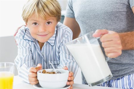 Father pouring milk for sons cereal at breakfast Stock Photo - Budget Royalty-Free & Subscription, Code: 400-06872769
