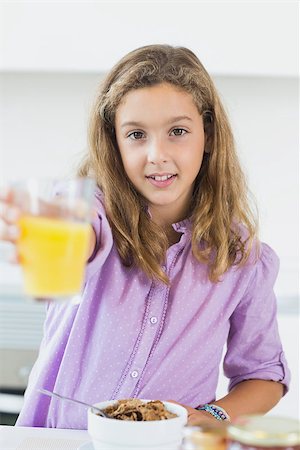 simsearch:400-06871178,k - Little girl offering orange juice at breakfast Stock Photo - Budget Royalty-Free & Subscription, Code: 400-06872777