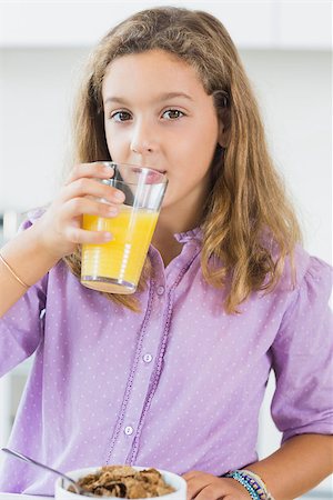 simsearch:400-06871178,k - Cute girl having orange juice at breakfast in kitchen Stock Photo - Budget Royalty-Free & Subscription, Code: 400-06872778