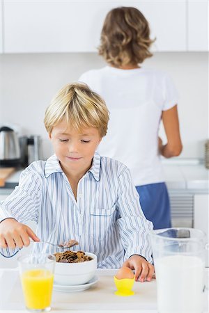 Young boy having breakfast in kitchen Stock Photo - Budget Royalty-Free & Subscription, Code: 400-06872771