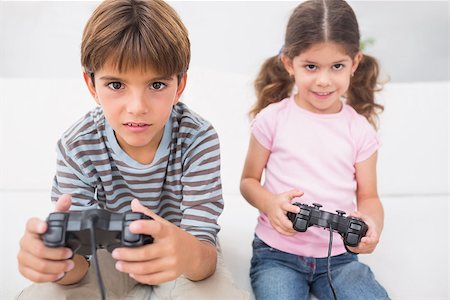 sofa two boys video game - Brother and sister playing video games together on the sofa Stock Photo - Budget Royalty-Free & Subscription, Code: 400-06872898