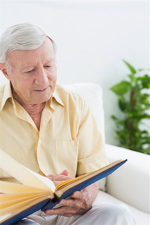 photoalbums inside - Elderly man watching his pictures on a sofa Stock Photo - Budget Royalty-Free & Subscription, Code: 400-06873158