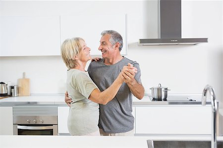 Couple dancing together in the kitchen Stock Photo - Budget Royalty-Free & Subscription, Code: 400-06873260