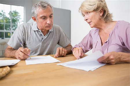 Couple discussing with documents on the table Stock Photo - Budget Royalty-Free & Subscription, Code: 400-06873279