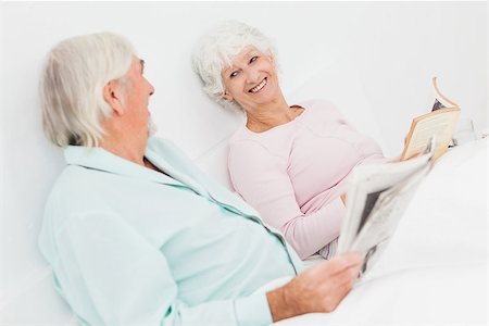 Elderly couple smiling at each other in bed Stock Photo - Budget Royalty-Free & Subscription, Code: 400-06873350