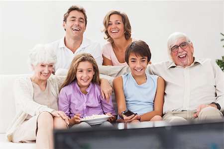senior man watching tv family - Extended family watching tv together on the couch Stock Photo - Budget Royalty-Free & Subscription, Code: 400-06873412