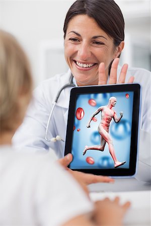 Smiling doctor showing a tablet computer to a child in hospital ward Stock Photo - Budget Royalty-Free & Subscription, Code: 400-06873501