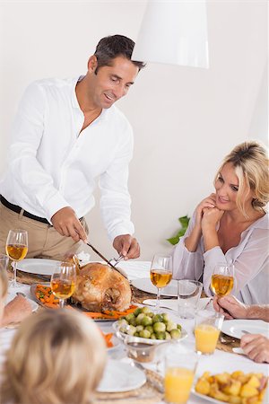 simsearch:400-06871551,k - Father carving the turkey at the head of table at thanksgiving Stock Photo - Budget Royalty-Free & Subscription, Code: 400-06873656