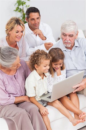 simsearch:400-06874610,k - Extended family watching laptop on the couch together Foto de stock - Super Valor sin royalties y Suscripción, Código: 400-06873650