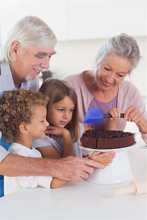 simsearch:400-06871551,k - Children with their grandparents icing a cake in the kitchen Stock Photo - Budget Royalty-Free & Subscription, Code: 400-06873670