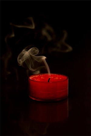 smoke in front of black - Burnt out candle on black background Stock Photo - Budget Royalty-Free & Subscription, Code: 400-06873706