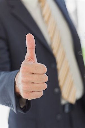 simsearch:400-06879262,k - Businessman showing thumbs up in office Stock Photo - Budget Royalty-Free & Subscription, Code: 400-06884147