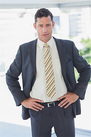 simsearch:400-06879262,k - Serious businessman with hands on hips in office Stock Photo - Budget Royalty-Free & Subscription, Code: 400-06884141
