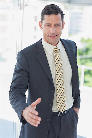 simsearch:400-06879262,k - Businessman offfering hand for handshake in office Stock Photo - Budget Royalty-Free & Subscription, Code: 400-06884142