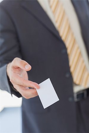 simsearch:400-06879262,k - Businessman giving a white blank business card in office Stock Photo - Budget Royalty-Free & Subscription, Code: 400-06884156