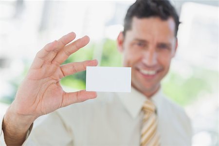 simsearch:400-06879262,k - Businessman presenting blank business card in office Stock Photo - Budget Royalty-Free & Subscription, Code: 400-06884157