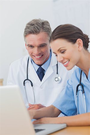 simsearch:6109-06781530,k - Two cheerful doctors working on a laptop in a medical office Photographie de stock - Aubaine LD & Abonnement, Code: 400-06884204