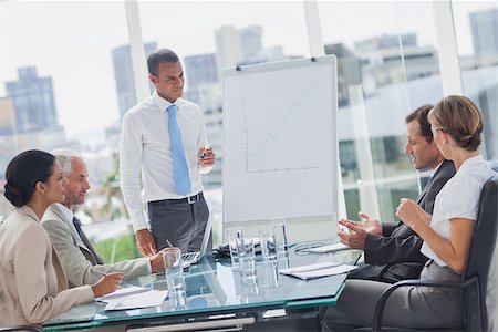 simsearch:400-06879262,k - Manager standing in front of colleagues during a meeting Stock Photo - Budget Royalty-Free & Subscription, Code: 400-06884533