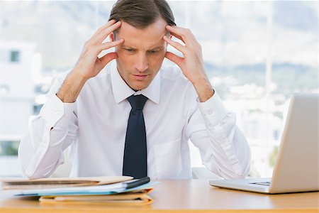 simsearch:693-03314173,k - Worried businessman holding his head in his office Stock Photo - Budget Royalty-Free & Subscription, Code: 400-06884568