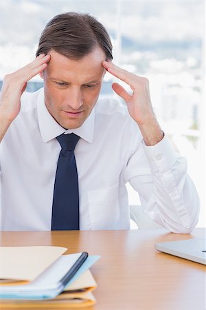 simsearch:693-03314173,k - Anxious businessman holding his head in his office Photographie de stock - Aubaine LD & Abonnement, Code: 400-06884569
