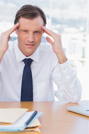 simsearch:693-03314173,k - Stressed businessman holding his head in his office Stock Photo - Budget Royalty-Free & Subscription, Code: 400-06884570