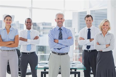 simsearch:400-06879270,k - Team of smiling business people standing with arms folded in the boardroom Stock Photo - Budget Royalty-Free & Subscription, Code: 400-06884572