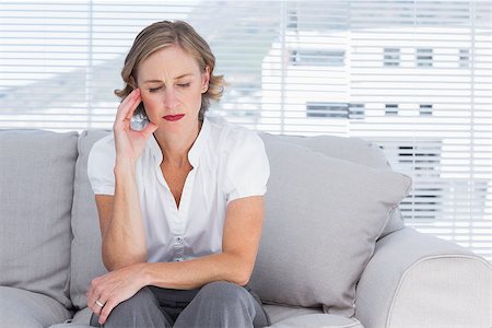 Worried businesswoman sitting on couch Stock Photo - Budget Royalty-Free & Subscription, Code: 400-06884686