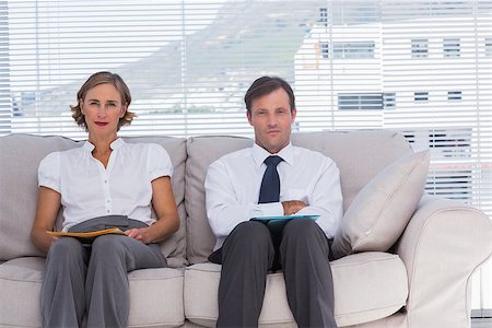 Two business people in a waiting room sitting on couch Stock Photo - Budget Royalty-Free & Subscription, Code: 400-06884726